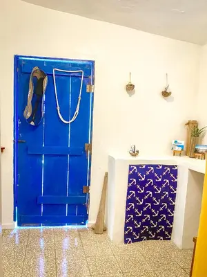 a blue door in the corner of a room at Local vacation beach house in Santa Cruz de Barahona
