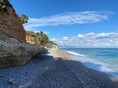 a rocky beach next to the ocean at Local vacation beach house in Santa Cruz de Barahona
