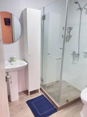 a bathroom with a shower and a toilet and a sink at Townhouse with Private Pool and nearby beaches in Punta Cana