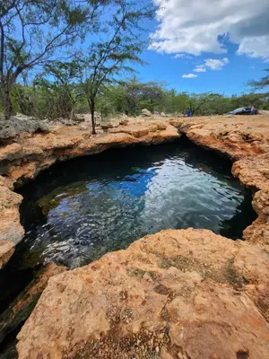 a pool of water in the middle of some rocks at Beachfront Apartment, Quiet 4 Beds, 1 Bath, AC, Wi-Fi, Hot Water, in Paraiso near Los Patos in Paraíso