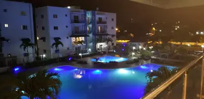 a view of a swimming pool at night at Caribean Dreams Apartement Beautiful Pool and Gym in Santiago de los Caballeros