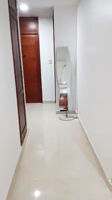 a bathroom with a mirror and a toilet in a room at Caribean Dreams Apartement Beautiful Pool and Gym in Santiago de los Caballeros