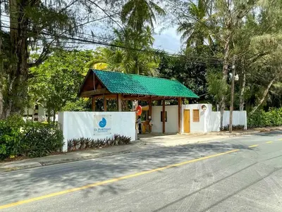 a small building with a green roof on the side of a street at Escape Beach Villa in El Portillo, Las Terrenas in Las Terrenas