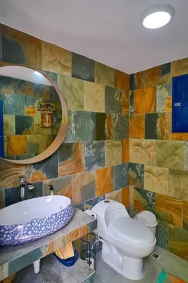 a bathroom with a sink and a toilet and a mirror at Escape Beach Villa in El Portillo, Las Terrenas in Las Terrenas