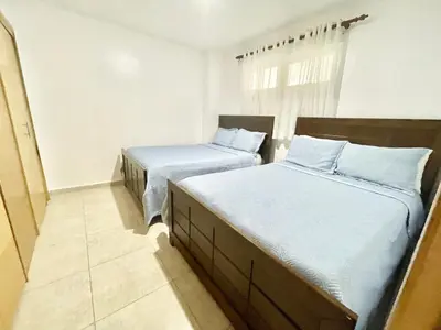 a bedroom with two beds and a window at Marbella 2bedroom Beachfront Apartment in San Pedro de Macorís