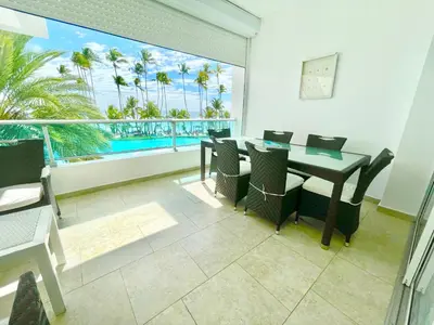a dining room with a table and a view of the ocean at Marbella 2bedroom Beachfront Apartment in San Pedro de Macorís