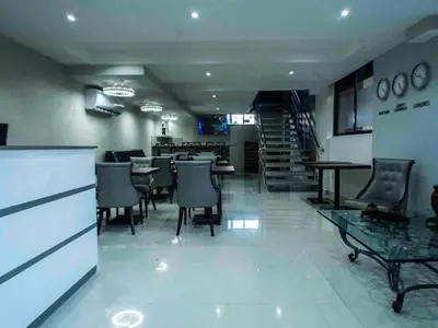 a restaurant with chairs and tables and a dining room at Malecon Premium Plus in Santo Domingo