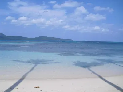 two shadows of people in the water on a beach at Caoba in Las Terrenas