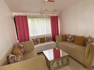 a living room with two couches and a chandelier at 9DR 3-Bedroom Apartment Near Monumental Area in Santiago de los Caballeros