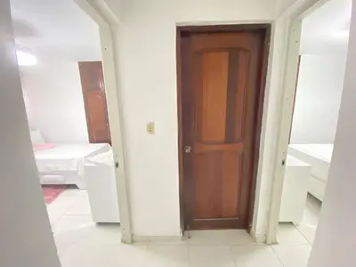 a hallway with a wooden door in a room at 9DR 3-Bedroom Apartment Near Monumental Area in Santiago de los Caballeros
