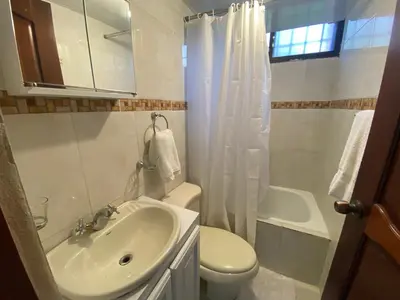 a bathroom with a sink and a toilet and a shower at 9DR 3-Bedroom Apartment Near Monumental Area in Santiago de los Caballeros