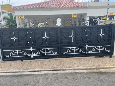 a black gate with white crosses on it at Maria's Entire House HIGUEY 2BD in Higuey