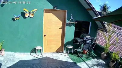 a door to a house with butterflies on the wall at Lovely tiny studio in Jarabacoa