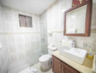 a bathroom with a sink and a toilet and a mirror at Stylish 1r-1b Apt Near The Beach And Main Street in Sosúa