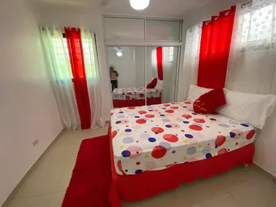 a bedroom with a red and white bed with polka dots at Santiago Center Huge Apartment 2stay rooftop to enjoy the city view 6-3 in Santiago de los Caballeros