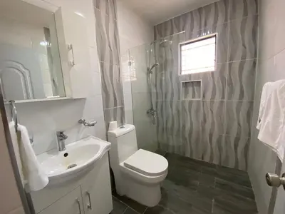 a bathroom with a white toilet and a sink at Santiago Center Huge Apartment 2stay rooftop to enjoy the city view 6-3 in Santiago de los Caballeros