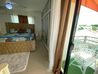 a bedroom with a bed and a balcony at Santiago Center Huge Apartment 2stay rooftop to enjoy the city view 6-3 in Santiago de los Caballeros