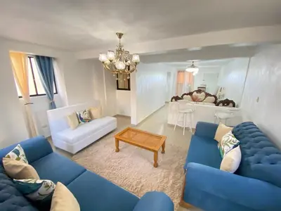 a living room with a blue couch and a table at 8 Santiago Monumental Area Cozy and lovely to enjoy 3 bedrooms Apart transportation 24 hours in Santiago de los Caballeros