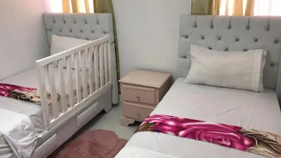a bedroom with two beds and a crib at 8 Santiago Monumental Area Cozy and lovely to enjoy 3 bedrooms Apart transportation 24 hours in Santiago de los Caballeros