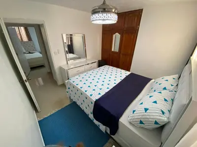 a small bedroom with a bed and a mirror at 8 Santiago Monumental Area Cozy and lovely to enjoy 3 bedrooms Apart transportation 24 hours in Santiago de los Caballeros