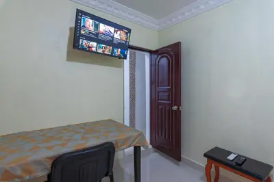 a room with a bed and a tv on the wall at Sunset Single Room Near Airport Wi-Fi & Parking in La Viva
