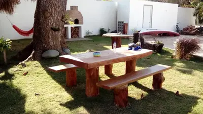a picnic table in a yard next to a tree at Studio Residencial Almendra in Cabarete
