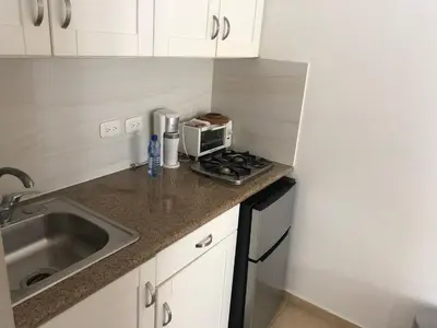 a small kitchen with a sink and a microwave at Studio Residencial Almendra in Cabarete