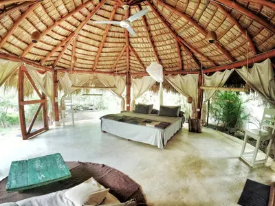 a large room with a bed in a tent at Jungle Hut near Beach - Nature Lovers in Las Terrenas