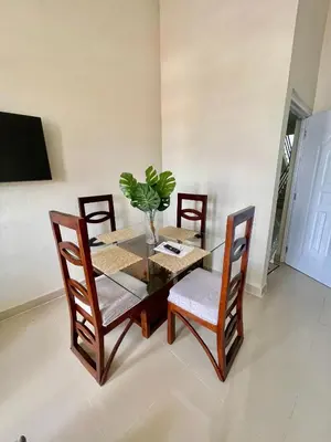 a dining room table and chairs with a plant on it at Balcón Skyline 2 in Jarabacoa