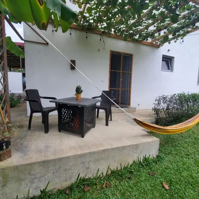 a patio with a table and chairs and a hammock at Apartamento los 3B in Manabao