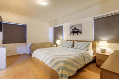 a bedroom with a bed and a flat screen tv at Escape 3BR Apartment Close to Downtown Mall in Bella Vista in Santo Domingo