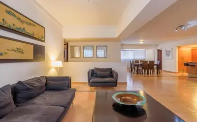 a living room with a couch and a table at Escape 3BR Apartment Close to Downtown Mall in Bella Vista in Santo Domingo