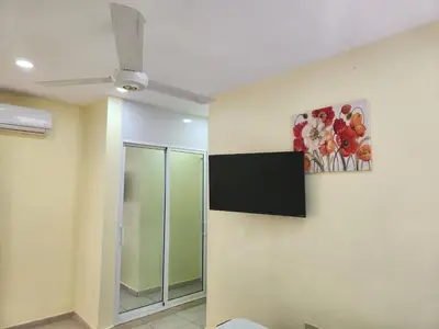 a room with a painting of flowers on the wall at Apartamentos Melya cerca de la Playa Caleta in La Romana