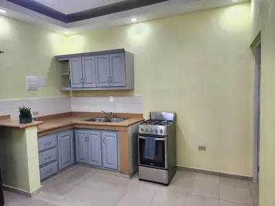 a kitchen with a stove and a sink in it at Apartamentos Melya cerca de la Playa Caleta in La Romana