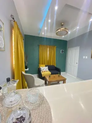 a living room with a table and a couch at Apartamentos Melya cerca de la Playa Caleta in La Romana