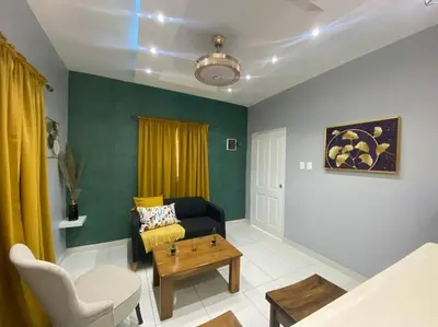a living room with a couch and a table at Apartamentos Melya cerca de la Playa Caleta in La Romana