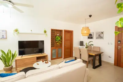 a living room with a white couch and a tv at Amazing Ocean Front - 2 bedroom Apartment (117 sq meters) in Cabarete