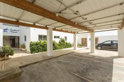 a large garage with a car parked in it at Amazing Ocean Front - 2 bedroom Apartment (117 sq meters) in Cabarete