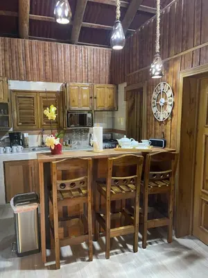 a kitchen with a large wooden table and chairs at Hacienda La Huerta Puerto Plata, 1 BDR in San Felipe de Puerto Plata