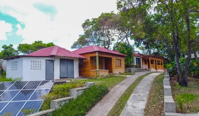 a row of houses with solar panels in front at Hacienda La Huerta Puerto Plata, 2 BDR in Maimón