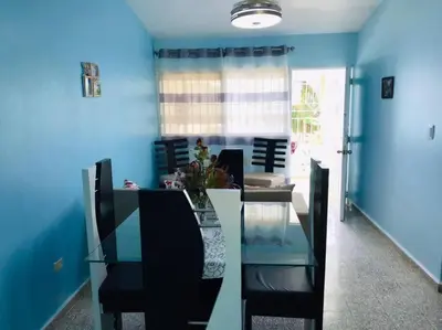 a dining room with blue walls and a glass table and chairs at Apto 2Habitaciones con Aire y Vista al Malecón de Samaná in Santa Bárbara de Samaná