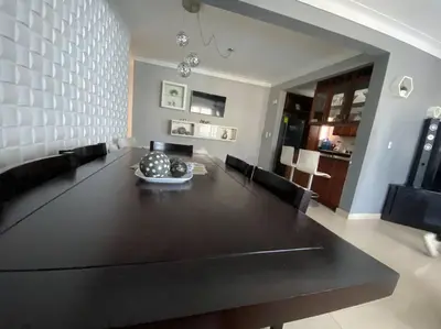 a dining room with a large black table and chairs at Self check in , moderno, A/C completo Wifi, TV 4K in Santiago de los Caballeros