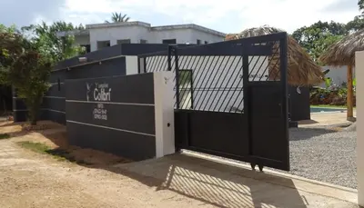 a black gate in front of a building at BUNGALOWS COLIBRI in Las Galeras