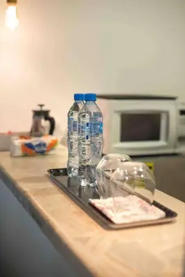 two bottles of water on a tray on a kitchen counter at Escape 2BR Apartment in Gazcue Close to Colonial Zone in Santo Domingo