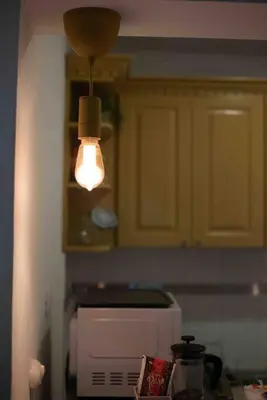 a kitchen with a light hanging over a microwave at Escape 2BR Apartment in Gazcue Close to Colonial Zone in Santo Domingo