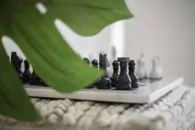 a chess board with black chess pieces on a table at New Beachfront Penthouse Punta Popy in Las Terrenas