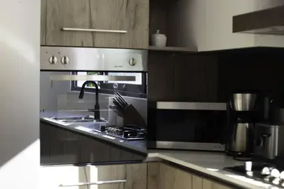 a kitchen with a stove top oven in a kitchen at New Beachfront Penthouse Punta Popy in Las Terrenas