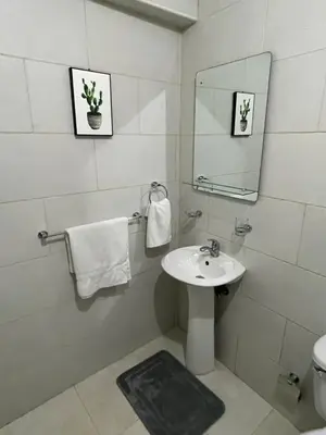 a white bathroom with a sink and a mirror at hospedaje de marant 2 in San Felipe de Puerto Plata