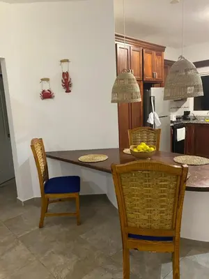 a kitchen with a table with chairs and a counter top at Espectacular BZII, bayahibe in Bayahibe