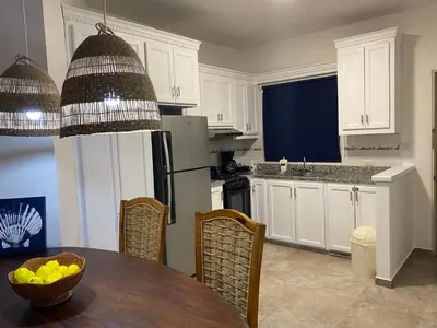 a kitchen with a table with a bowl of fruit on it at Espectacular BZII, bayahibe in Bayahibe